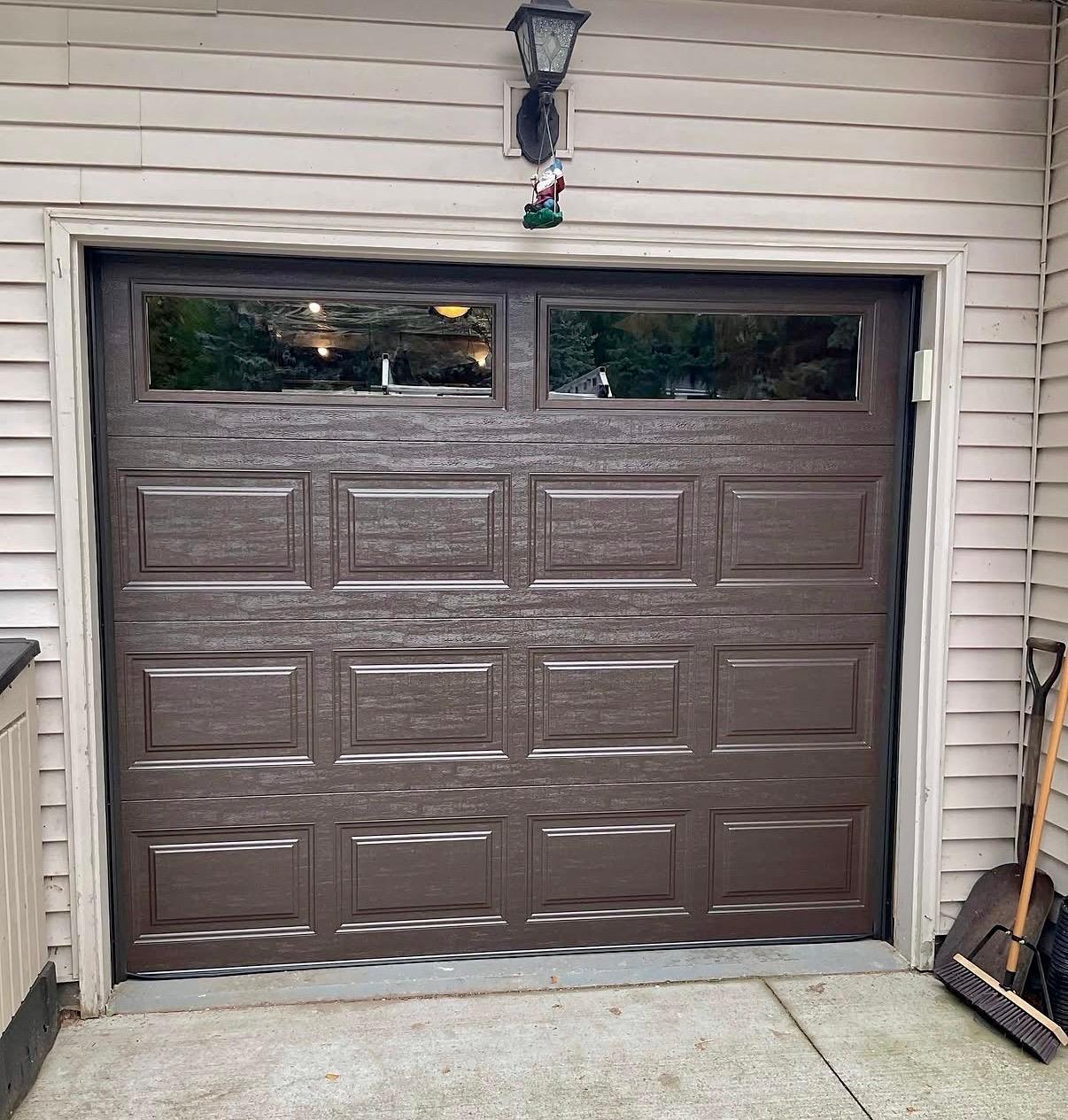 Bluefin dark wood-look garage door with windows installed